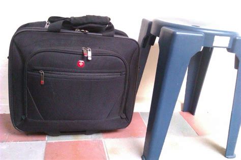 luggage with cross logo